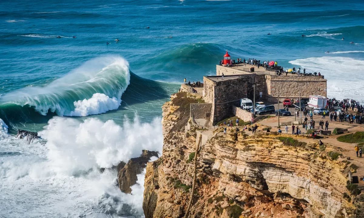 Huge waves crashing near the Fort of Nazaré lighthouse