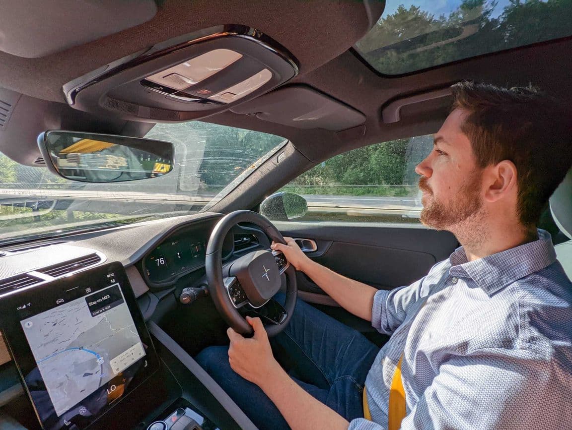 man driving electric car on motoroway