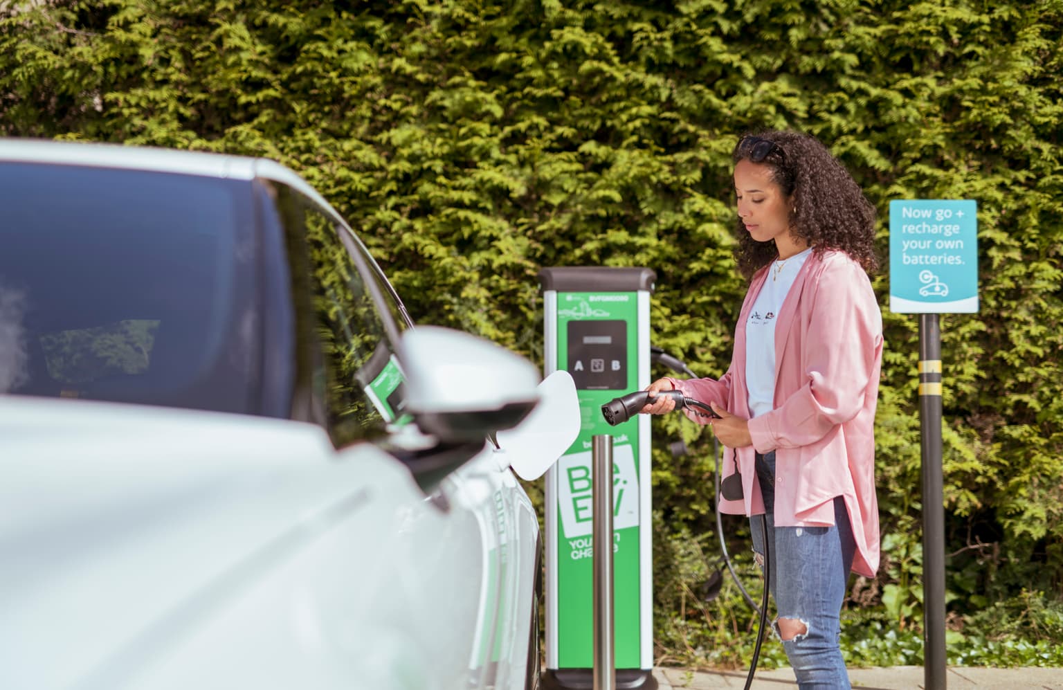 Woman using a be.ev ev charging point