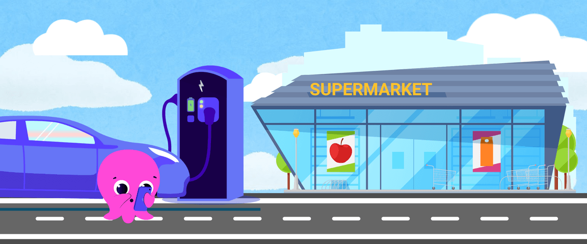 A cartoon octopus using a smartphone stands near an electric car charging station in front of a supermarket.
