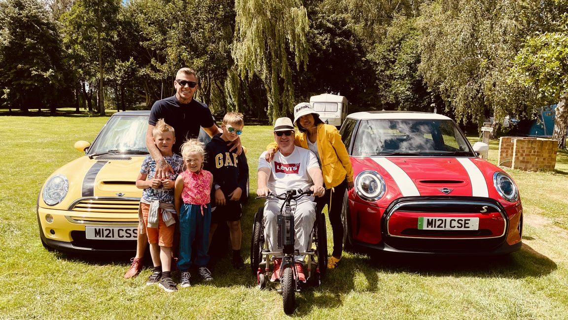 Image showing family of Roger Warner next to EVs