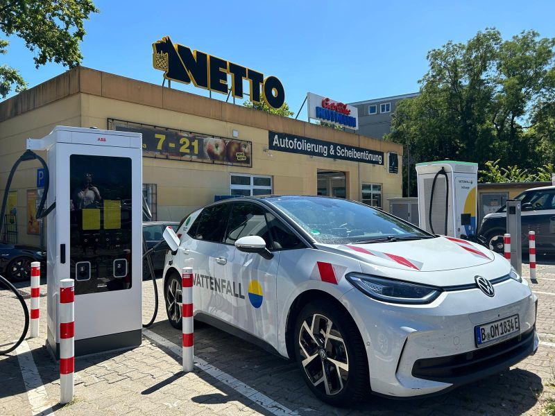 Electric Volkswagen charging at a Netto parking lot, with "Vattenfall" branding.